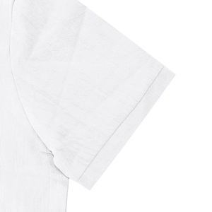 Detail of white cotton linen shirt sleeve showing natural fiber texture and stitching