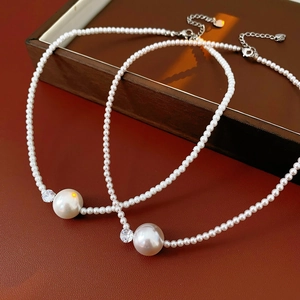 Dettaglio di collana di perle a doppio strato con pendente di perla grande e zircone