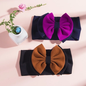 Detail of baby headbands with double bows featuring soft waffle texture in various colors