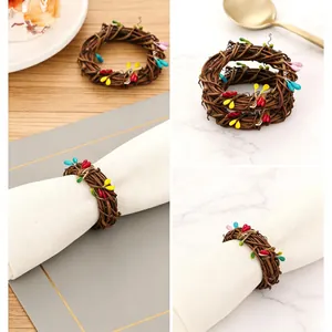 Handwoven rattan napkin rings with colorful berry beads set on white napkins