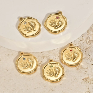 Five gold stainless steel baby hand and footprint pendants with colorful stones on stone base
