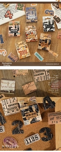 Detailed view of vintage scrapbook stickers with gold stamping in a retro kraft box