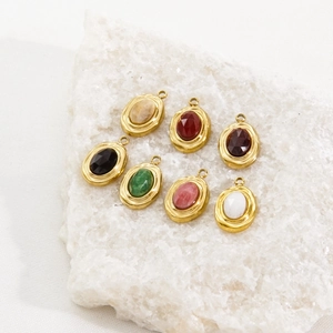 Detail of colorful faceted natural stone pendants with gold metal edges on a crystal