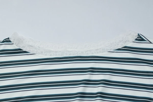 Detail of elegant lace collar on striped knit long-sleeve shirt for women