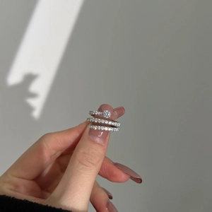 S925 sterling silver stacked ring set with spiral zircon held in hand with soft lighting