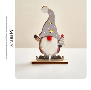 Close-up of wooden Christmas gnome with LED lights, warm star cutouts and white beard