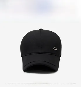 Front view of black winter baseball cap with ear flaps and a small metal mountain logo