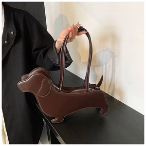 Detail of creative dachshund shaped dark brown leather handbag with zipper and twin handles
