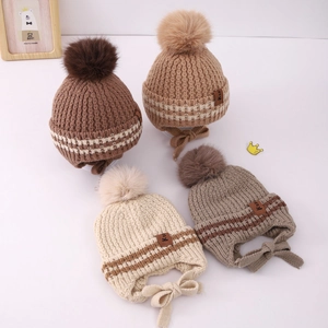 Winter knit baby hats with pom-poms and earflaps in four neutral earth-tone colors