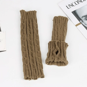 Macro detail of brown knit arm warmers featuring classic cable knit pattern and thumb hole