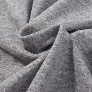 Close-up of grey knitted fabric texture showing soft brushed fibers and premium weave details