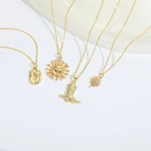 Set of four gold necklaces featuring tulip, sun god, cowboy boot, and star pendants
