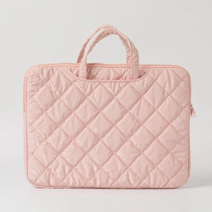 Close-up of pink quilted laptop bag with durable metal zipper and padded handles