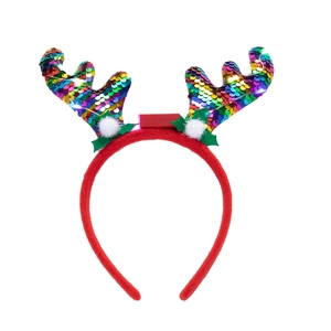 Detail of reindeer antler headband with colorful sequins, holly leaves and white pom-poms