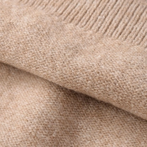 Soft beige knit top for women with detailed ribbed hem and fine wool texture