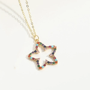 Macro shot of gold star pendant set with vibrant multicolored zircon gemstones