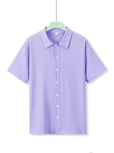 Detail of light purple seersucker shirt collar with M size tag and textured fabric weave