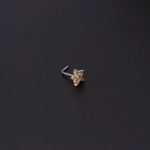 Macro view of a 20G L-shaped gold flower nose stud with clear cubic zirconia stones