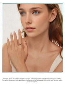 Close-up of infinity heart two-tone silver ring worn on a finger for daily wear