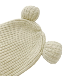 Close-up of the fine knit texture and cute 3D bear ear detail on this beige winter hat