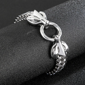 Detailed close-up of double wolf head clasp and thick stainless steel cuban chain link