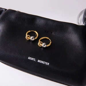 Detail of two-tone hoop earrings with gold pavé crystals and silver bead accents