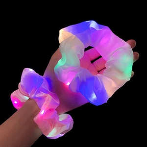 Close-up of glowing LED hair scrunchies with vibrant multi-color lights on wrist