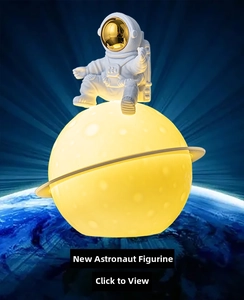 Detailed view of creative astronaut figure holding a glowing lunar planet night light