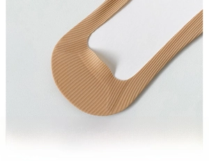 Macro view of seamless nude no-show socks featuring a 3D ergonomic anti-slip heel design