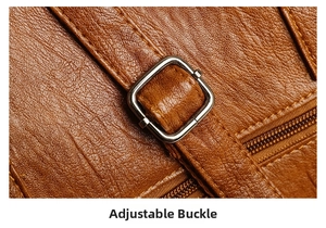 Detail of adjustable metal buckle and stitching on brown pebble grain leather bag strap