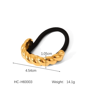 Detail view of 18K gold twisted metal charm on black elastic hair tie with size specs