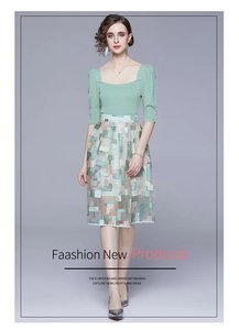 Detail of elegant fairy dress featuring knit short sleeve top and floral embroidery skirt