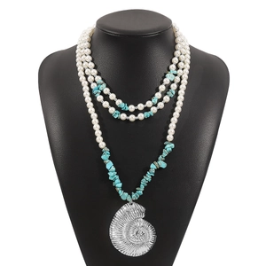 Bohemian multi-layer necklace with turquoise, pearls, and large silver conch shell pendant