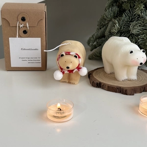 Polar bear scented candles in white and brown with kraft gift box and pine branch