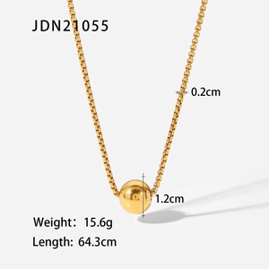 Close-up of golden box chain necklace with a 1.2cm polished sphere pendant for women