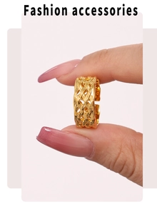 Detailed close-up of adjustable golden ring with elegant woven metal texture design
