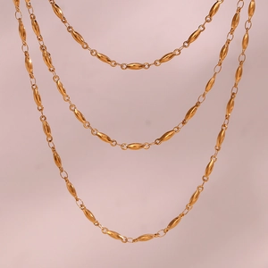 Detail of 18K gold plated stainless steel olive bead chain necklace with smooth texture