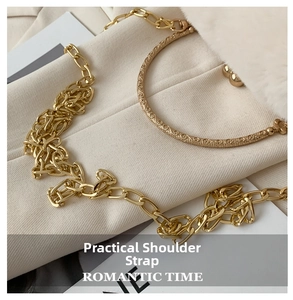 Detailed view of luxury golden metal chain strap with vintage embossed pattern handle