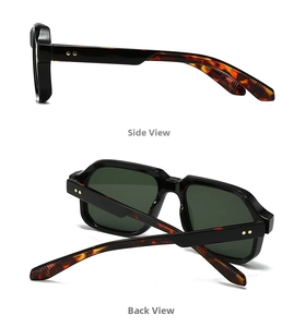 Detail view of vintage sunglasses with black frames and tortoise shell patterned temples