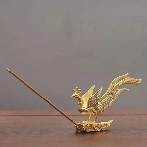 Detailed view of the golden phoenix incense burner featuring intricate feather textures