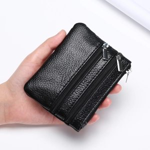 Handheld black pebble grain leather coin purse with three zipper compartments