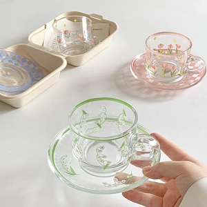 Set tazza e piattino in vetro con motivi floreali e piatti a scacchi colorati