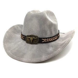 Detail of grey woven cowboy hat with brown band and bronze bull head buckle