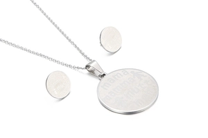 Detail of silver jewelry set with mama engravings and a child icon on the pendant and studs