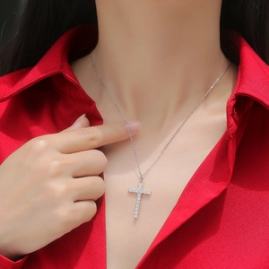Elegant 925 sterling silver cross pendant necklace with moissanite on a red shirt model