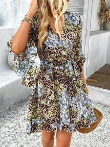 Detailed view of leopard print chiffon wrap dress with ruffled sleeves and waist tie