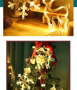 Detail view of warm white LED snowflake and reindeer hanging lights on a Christmas tree