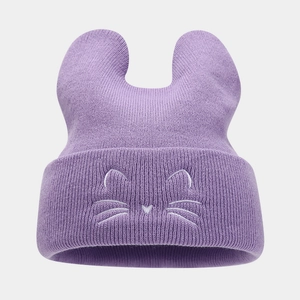 Close-up of purple knit cat ear hat featuring white facial embroidery and rolled edge