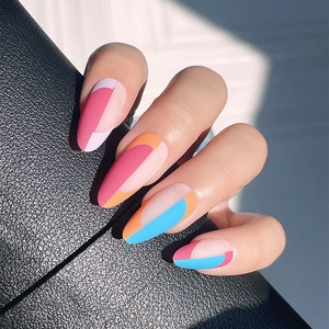 French almond fake nails with contrast geometric patterns on black leather texture