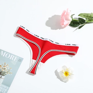 Detail of red ribbed cotton thong with Love You lettered waistband on white background